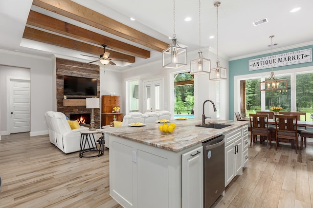 27647 N Salado Ct, Splendora, TX 77372 - kitchen featuring stainless steel dishwasher, light wood-type flooring, a stone fireplace, open floor plan, and recessed lighting