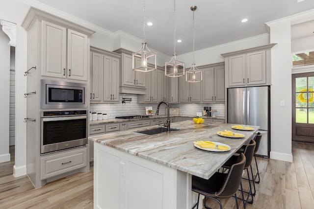 27647 N Salado Ct, Splendora, TX 77372 - kitchen featuring stainless steel appliances, light wood-type flooring, light stone countertops, decorative backsplash, and crown molding