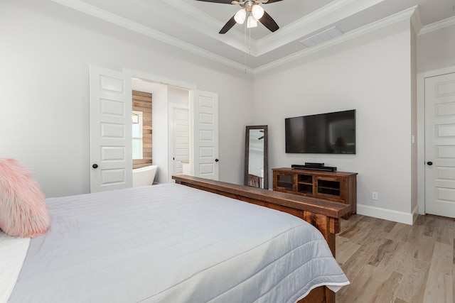 27647 N Salado Ct, Splendora, TX 77372 - bedroom featuring light wood finished floors, crown molding, ceiling fan, a tray ceiling, and ensuite bathroom