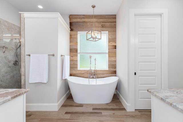 27647 N Salado Ct, Splendora, TX 77372 - bathroom with vanity, a chandelier, a freestanding bath, wood finished floors, and recessed lighting