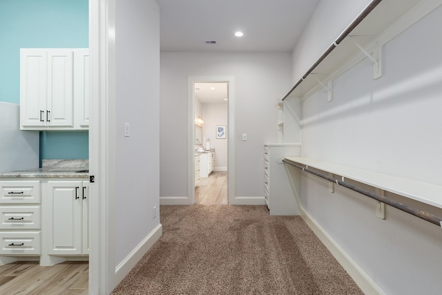 27647 N Salado Ct, Splendora, TX 77372 - walk in closet featuring light carpet