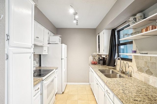 101 Stratford St Unit 103, Houston, TX 77006 - kitchen with white appliances, white cabinets, tasteful backsplash, light tile patterned floors, and light stone countertops