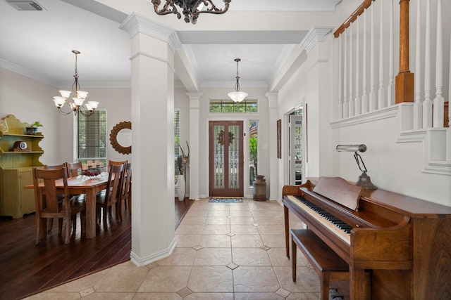 5814 Ashley Spring Ct, Katy, TX 77494 - entryway featuring a chandelier, ornate columns, crown molding, and light tile patterned floors