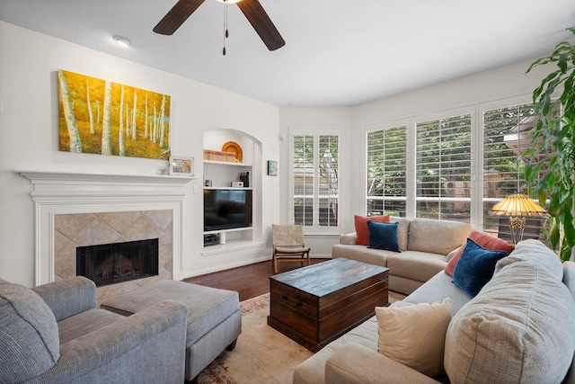 5814 Ashley Spring Ct, Katy, TX 77494 - living area with a premium fireplace, wood finished floors, ceiling fan, and built in shelves
