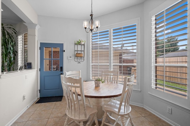 5814 Ashley Spring Ct, Katy, TX 77494 - dining area with light tile patterned floors, plenty of natural light, a chandelier, and decorative columns