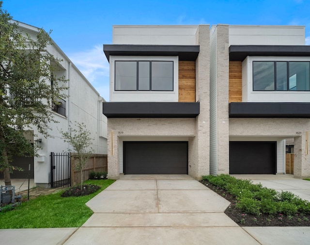 822 E 25th St, Houston, TX 77009 - modern home featuring an attached garage, concrete driveway, and brick siding