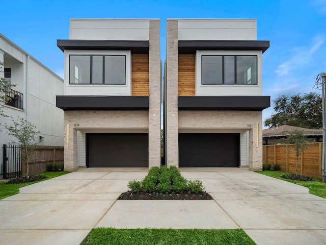 822 E 25th St, Houston, TX 77009 - contemporary home with a garage, driveway, and brick siding