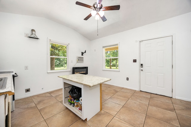 125 James Blvd, Livingston, TX 77351 - kitchen with lofted ceiling, ceiling fan, light tile patterned floors, a kitchen island, and open shelves