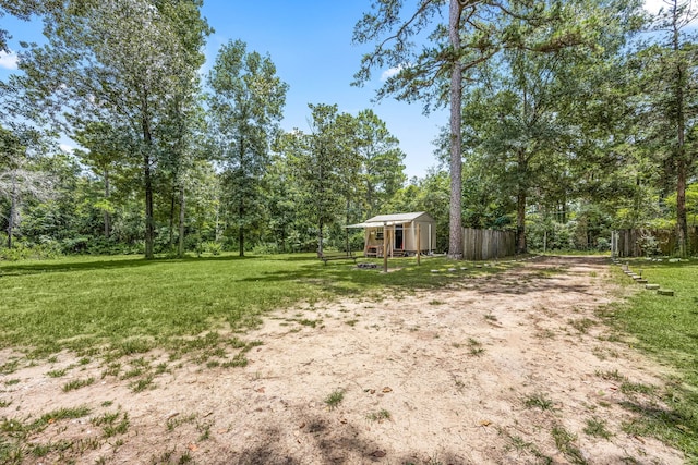 125 James Blvd, Livingston, TX 77351 - view of green lawn with a storage shed
