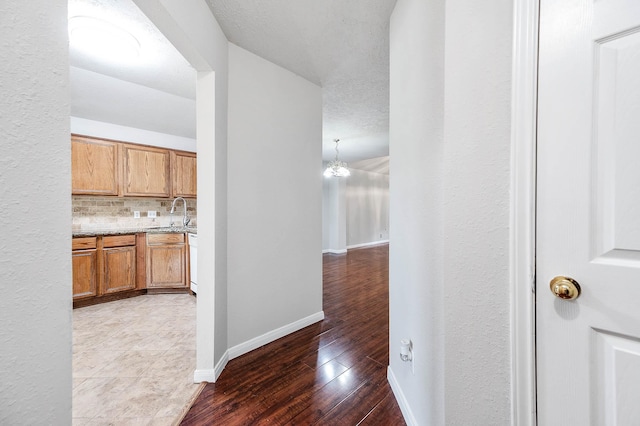 9911 Pierre Ct, Houston, TX 77089 - corridor with wood finished floors and a chandelier