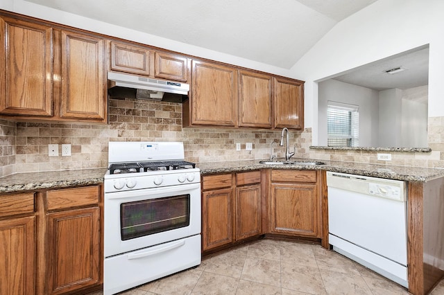 9911 Pierre Ct, Houston, TX 77089 - kitchen with white appliances, under cabinet range hood, lofted ceiling, and brown cabinetry