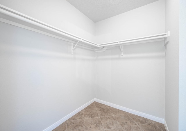 9911 Pierre Ct, Houston, TX 77089 - spacious closet with light tile patterned floors