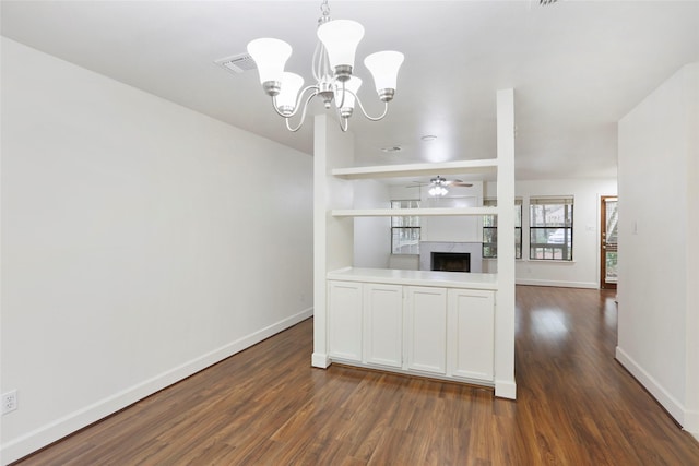 28 Sawmill Grove Ln, The Woodlands, TX 77380 - unfurnished dining area featuring dark wood-style flooring, a chandelier, a fireplace, and a ceiling fan