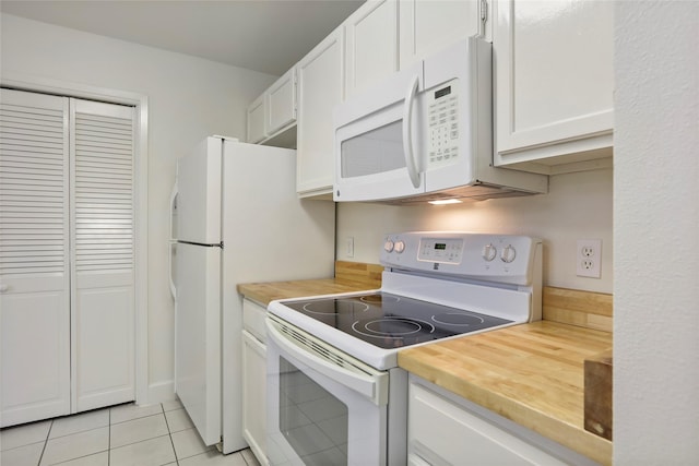 28 Sawmill Grove Ln, The Woodlands, TX 77380 - kitchen featuring white appliances, white cabinets, light tile patterned floors, and wood counters