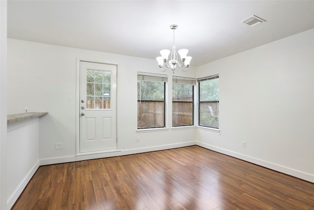 28 Sawmill Grove Ln, The Woodlands, TX 77380 - unfurnished dining area with a chandelier and wood finished floors