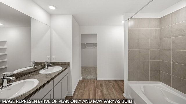5434 Magnolia Heath Ln, Spring, TX 77373 - full bath featuring double vanity, wood finished floors, a walk in closet, bathing tub / shower combination, and recessed lighting