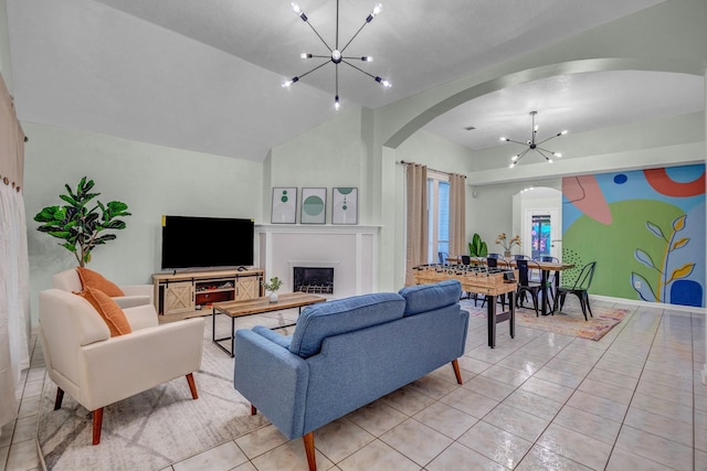 8222 Viny Ridge Dr, Houston, TX 77083 - living area with a chandelier, arched walkways, vaulted ceiling, a fireplace, and light tile patterned floors