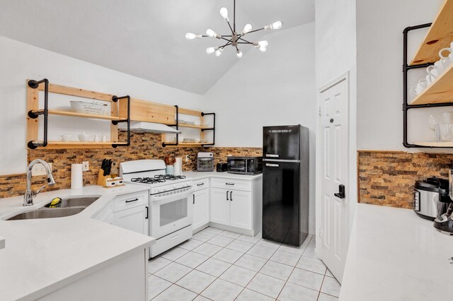 8222 Viny Ridge Dr, Houston, TX 77083 - kitchen featuring gas range gas stove, freestanding refrigerator, open shelves, tasteful backsplash, and high vaulted ceiling