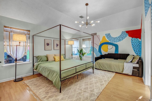 8222 Viny Ridge Dr, Houston, TX 77083 - bedroom featuring wood finished floors, a chandelier, and lofted ceiling