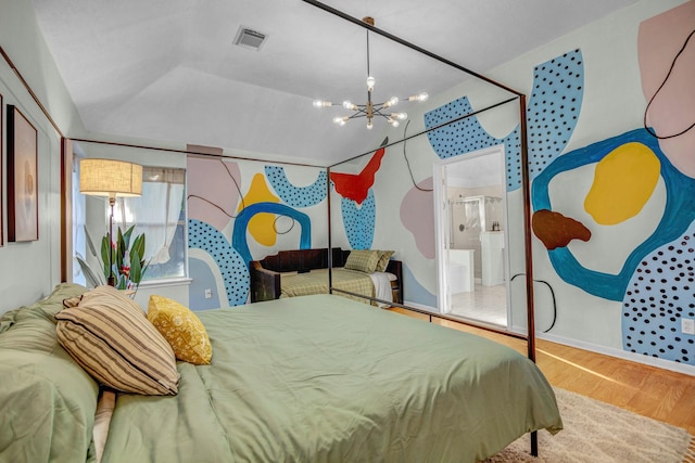 8222 Viny Ridge Dr, Houston, TX 77083 - bedroom featuring a chandelier, wood finished floors, lofted ceiling, and ensuite bath