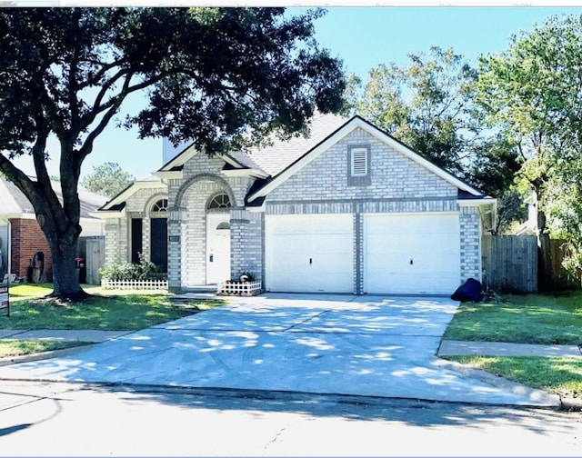 8222 Viny Ridge Dr, Houston, TX 77083 - view of front of home featuring concrete driveway, a garage, and brick siding