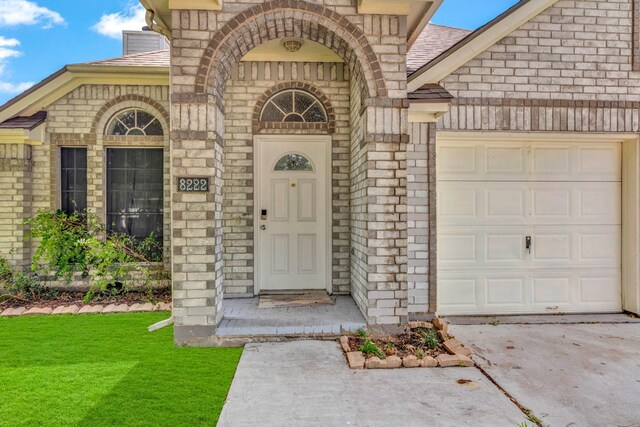 8222 Viny Ridge Dr, Houston, TX 77083 - entrance to property with an attached garage, brick siding, driveway, and roof with shingles