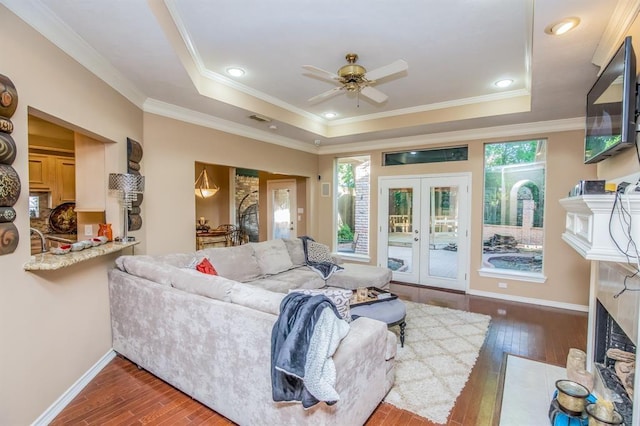 6242 Agassi Ace Ct, Spring, TX 77379 - living room with a raised ceiling, plenty of natural light, ceiling fan, wood-type flooring, and ornamental molding