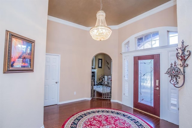6242 Agassi Ace Ct, Spring, TX 77379 - foyer entrance with a chandelier, wood finished floors, ornamental molding, arched walkways, and a high ceiling