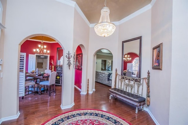6242 Agassi Ace Ct, Spring, TX 77379 - foyer entrance featuring a chandelier, a towering ceiling, wood finished floors, crown molding, and arched walkways