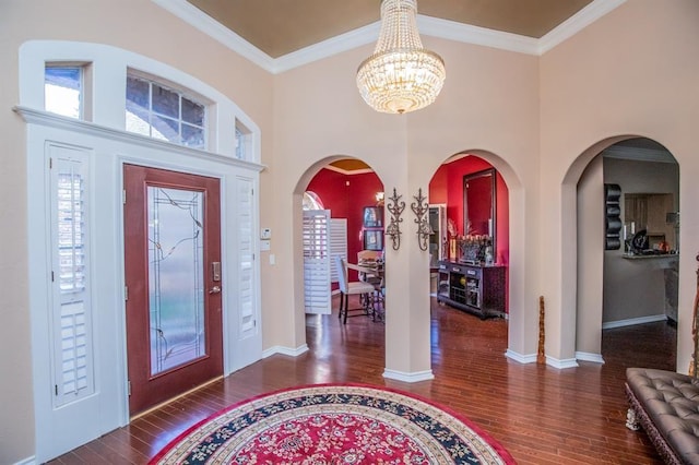 6242 Agassi Ace Ct, Spring, TX 77379 - entryway featuring a chandelier, wood finished floors, ornamental molding, arched walkways, and a high ceiling