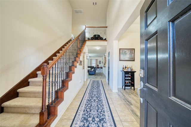 4719 Echo Bay Dr, Baytown, TX 77523 - foyer with a towering ceiling, stairway, and light tile patterned flooring