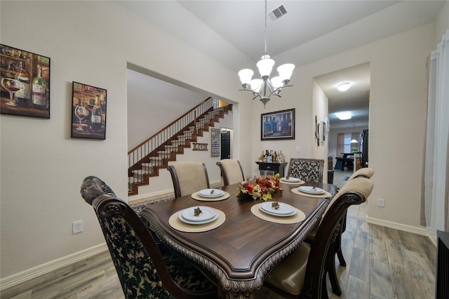 4719 Echo Bay Dr, Baytown, TX 77523 - dining room featuring a chandelier, wood finished floors, and stairway