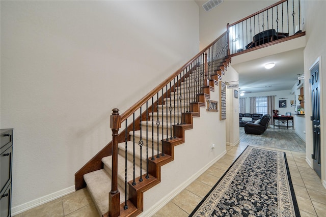 4719 Echo Bay Dr, Baytown, TX 77523 - stairway with tile patterned floors and a towering ceiling