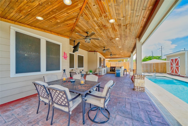 4719 Echo Bay Dr, Baytown, TX 77523 - view of patio with outdoor dining space, a storage shed, and a ceiling fan
