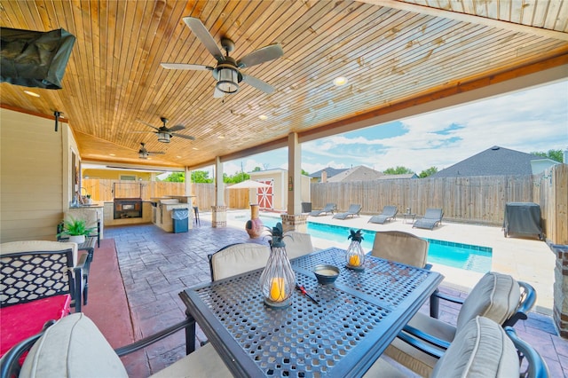 4719 Echo Bay Dr, Baytown, TX 77523 - fenced backyard featuring outdoor dining area, a storage shed, a patio, and ceiling fan