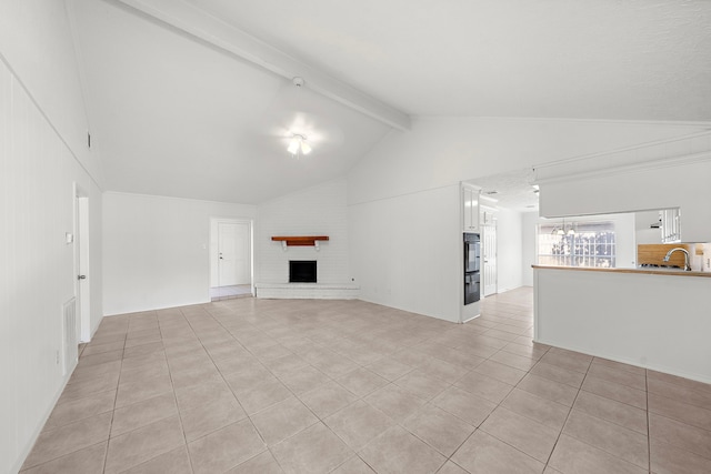 1517 Van Buren Dr, Deer Park, TX 77536 - unfurnished living room with light tile patterned flooring, a fireplace, high vaulted ceiling, and beamed ceiling