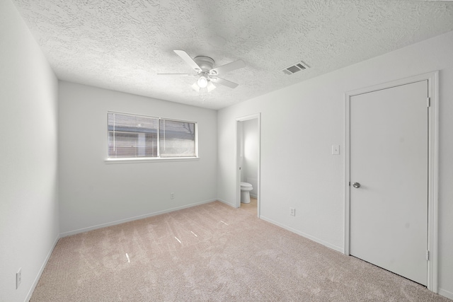 1517 Van Buren Dr, Deer Park, TX 77536 - unfurnished bedroom with light carpet, ensuite bathroom, a textured ceiling, and ceiling fan