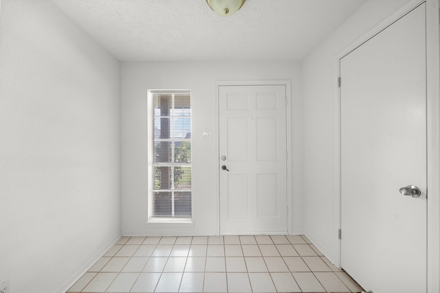 1517 Van Buren Dr, Deer Park, TX 77536 - foyer featuring light tile patterned floors and a textured ceiling