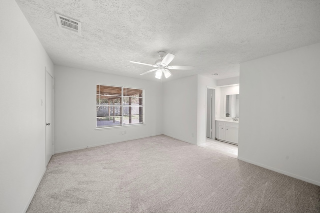 1517 Van Buren Dr, Deer Park, TX 77536 - spare room with light colored carpet, ceiling fan, and a textured ceiling