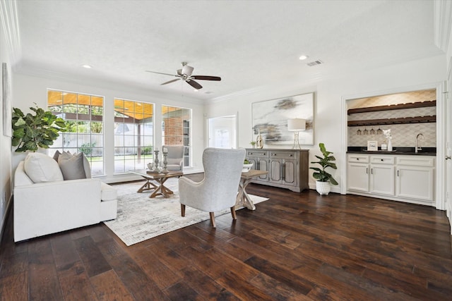 13418 Pristine Park Dr, Houston, TX 77041 - living room with crown molding, ceiling fan, dark wood-style flooring, bar area, and recessed lighting
