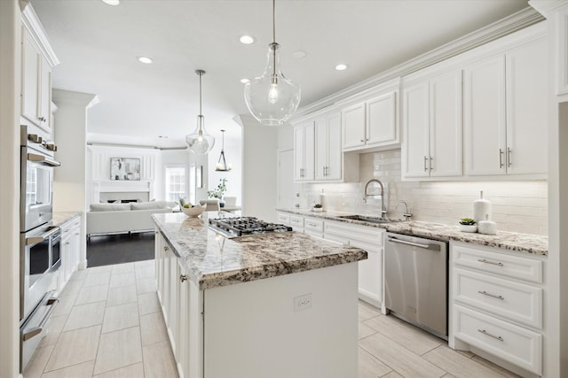 13418 Pristine Park Dr, Houston, TX 77041 - kitchen with appliances with stainless steel finishes, a warming drawer, open floor plan, a kitchen island, and decorative backsplash