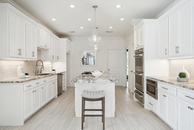 13418 Pristine Park Dr, Houston, TX 77041 - kitchen featuring a warming drawer, stainless steel appliances, a center island, white cabinetry, and recessed lighting