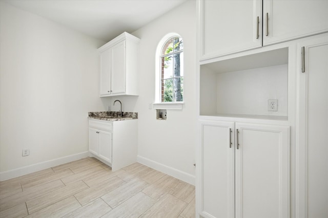 13418 Pristine Park Dr, Houston, TX 77041 - washroom with hookup for a washing machine, light wood-type flooring, and cabinet space