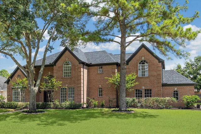 13418 Pristine Park Dr, Houston, TX 77041 - view of front facade featuring brick siding, a front yard, and roof with shingles