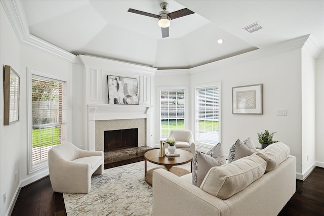 13418 Pristine Park Dr, Houston, TX 77041 - living area with a tray ceiling, ornamental molding, a ceiling fan, a tiled fireplace, and plenty of natural light