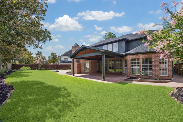 13418 Pristine Park Dr, Houston, TX 77041 - rear view of house with brick siding, a fenced backyard, a patio, a shingled roof, and a chimney