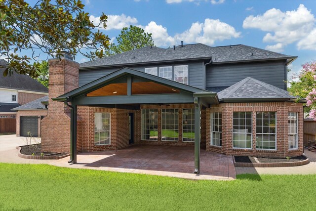 13418 Pristine Park Dr, Houston, TX 77041 - back of property featuring a patio area, a shingled roof, brick siding, and a chimney