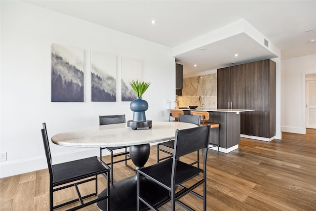 1701 Hermann Dr Unit 23B, Houston, TX 77004 - dining room featuring wood finished floors and recessed lighting