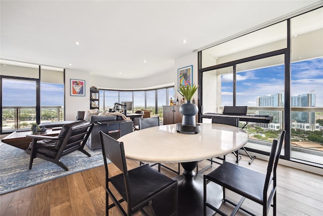 1701 Hermann Dr Unit 23B, Houston, TX 77004 - dining room featuring wood finished floors, a view of city, and recessed lighting
