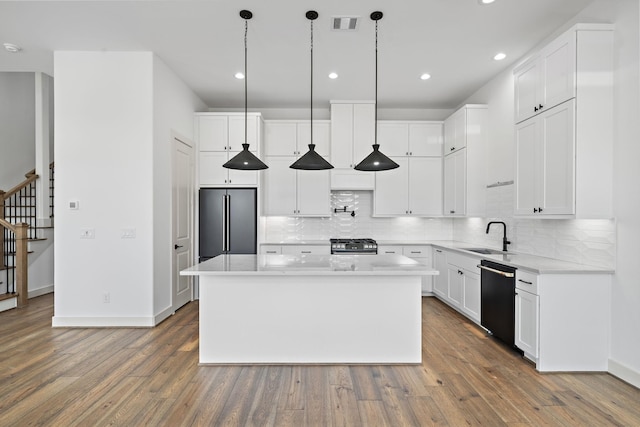 1706 Sedola Ln, Houston, TX 77055 - kitchen featuring stainless steel appliances, dark wood-style floors, tasteful backsplash, white cabinets, and recessed lighting